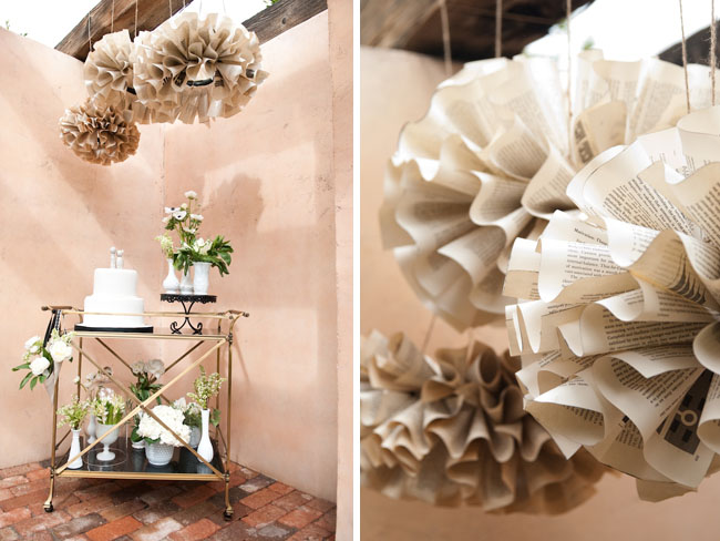 Such a pretty cake table display hanging paper balls from old books