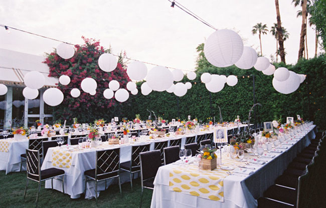 With a cascade of chinese lanterns long tables for wedding reception