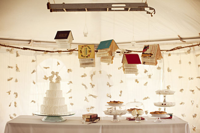 hanging books at a wedding over dessert table